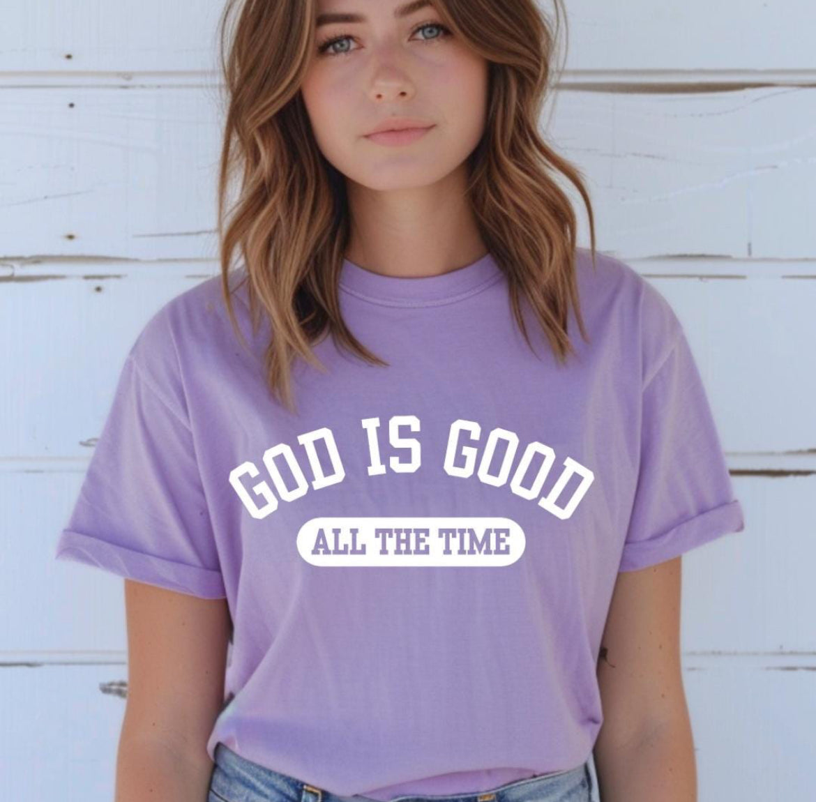 Lavender crewneck t-shirt that says, “God is good all the time”.