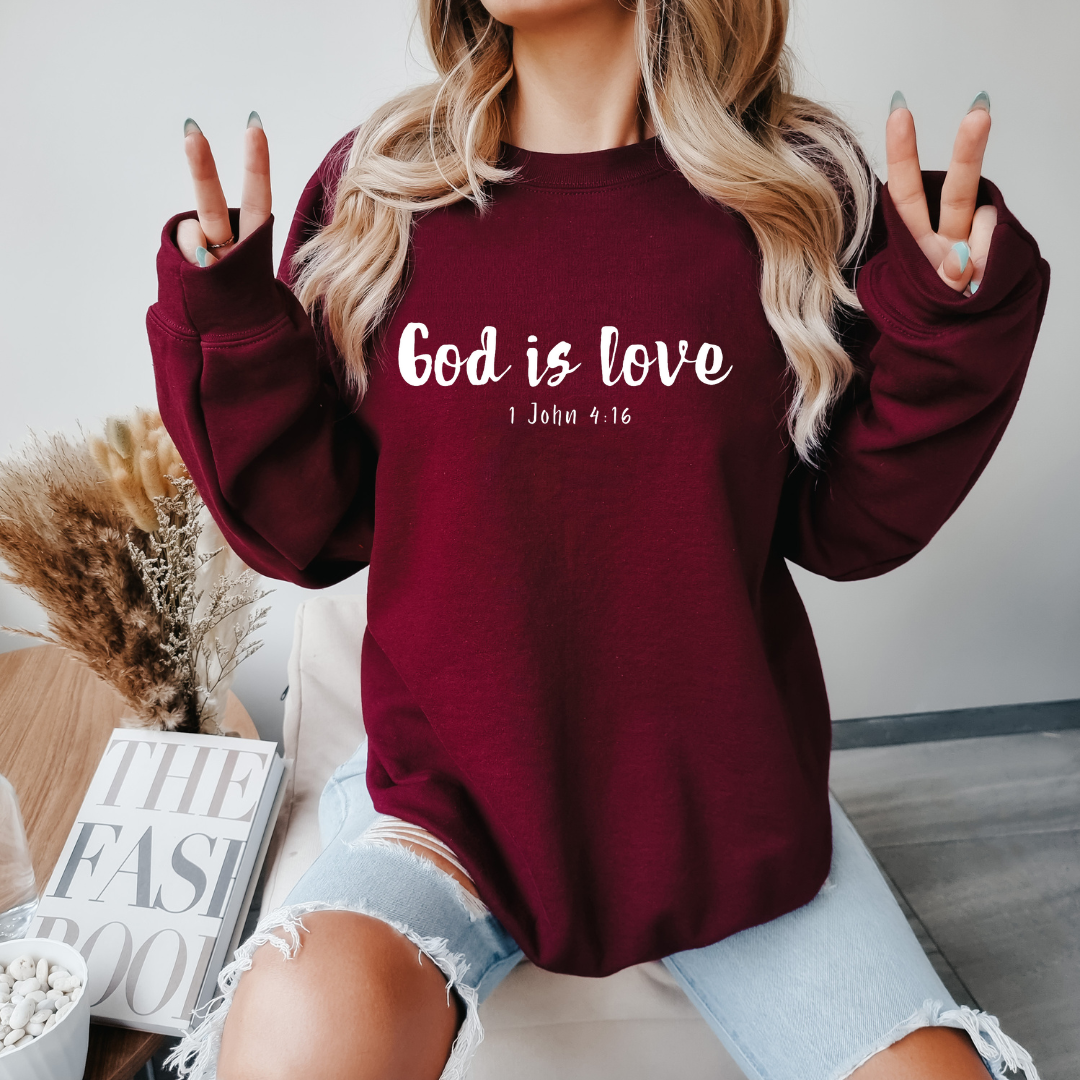 Maroon crewneck sweatshirt that says, “God is love. 1 John 4:16.”