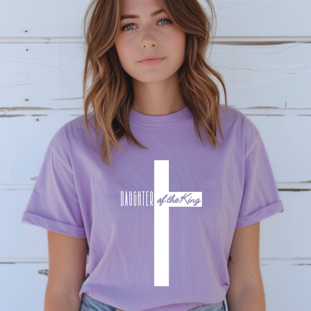 Lavender crewneck t-shirt that says, “Daughter of the King” running through a cross.