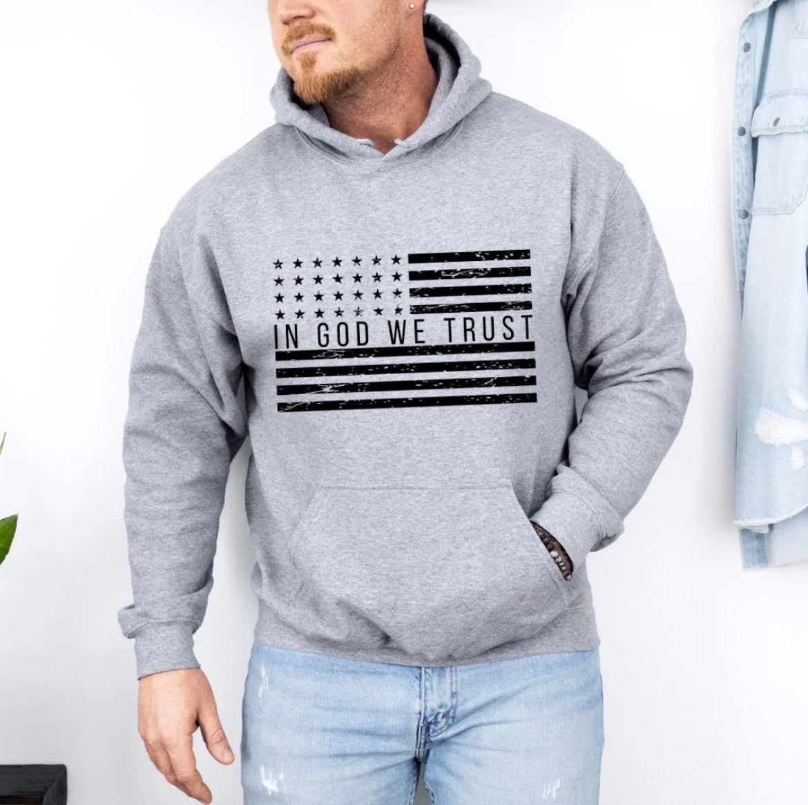 Light gray hoodie with a distressed American flag that says, "In God we trust" across the middle of the flag.