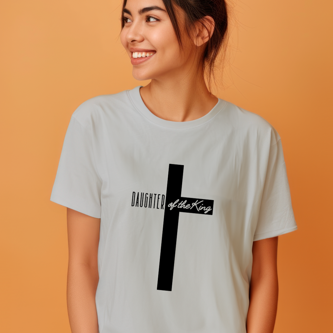 Grey crewneck t-shirt that says, “Daughter of the King” running through a cross.