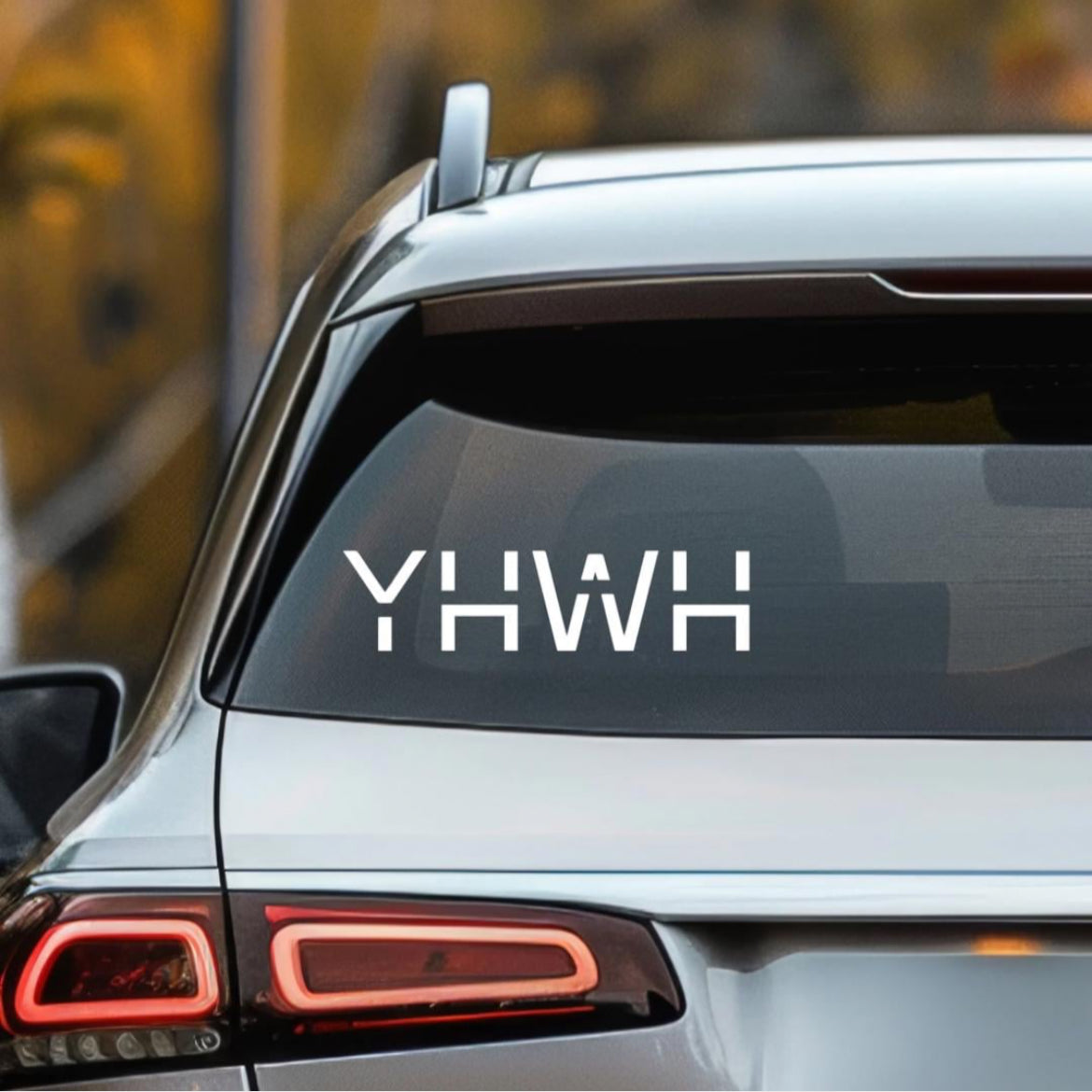 Car decal sticker that says, “YHWH” in large capital letters.