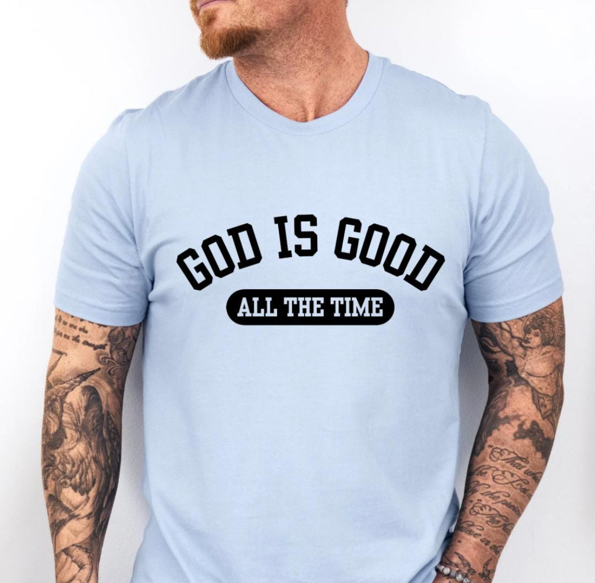 Baby blue crewneck t-shirt that says, “God is good all the time”.