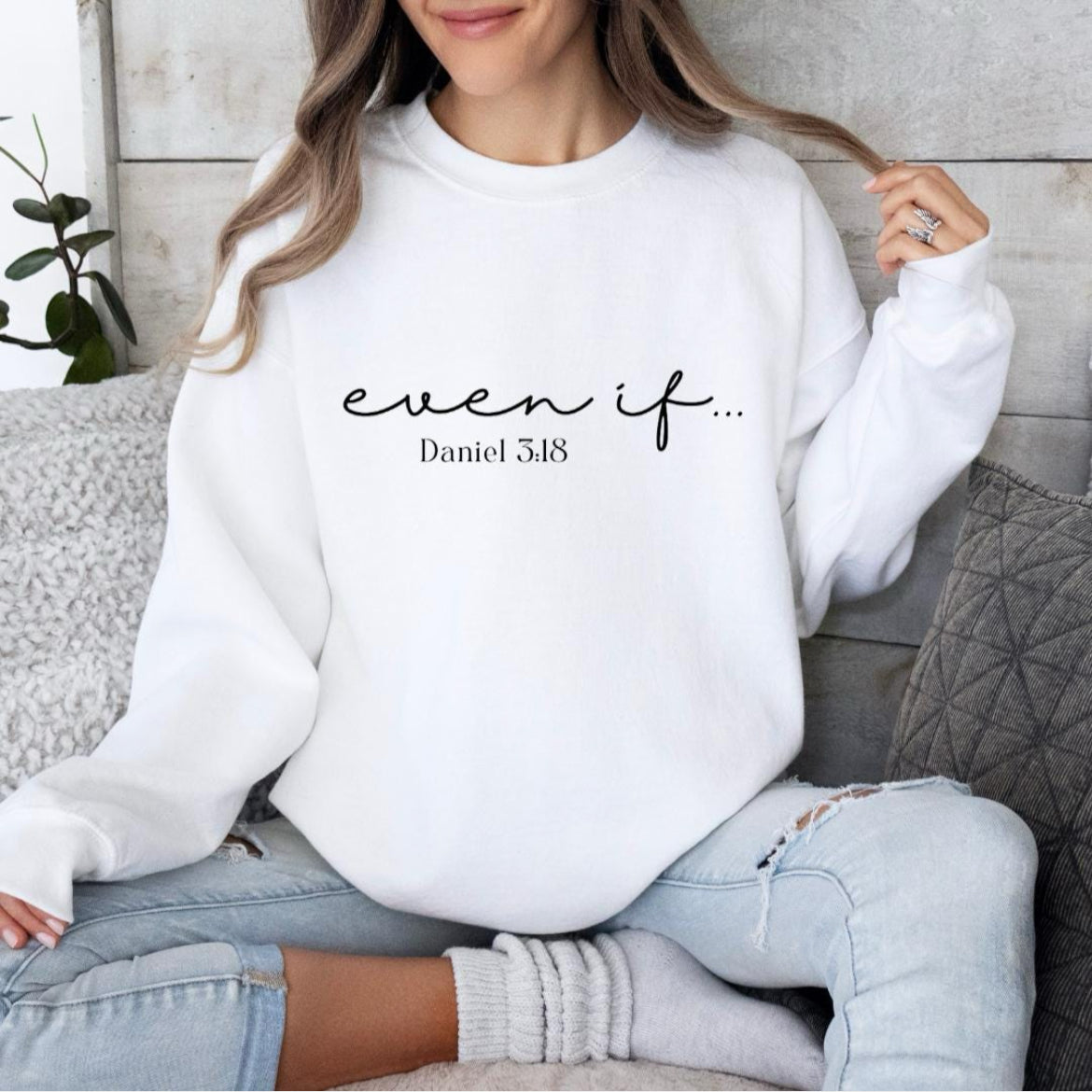White crewneck sweatshirt that says, "Even if" in large cursive letters. Underneath it says, "Daniel 3:18."
