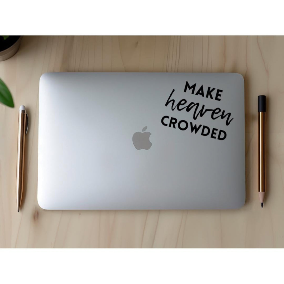 Laptop decal sticker that says, “make heaven crowded.” The word “heaven” is in cursive.