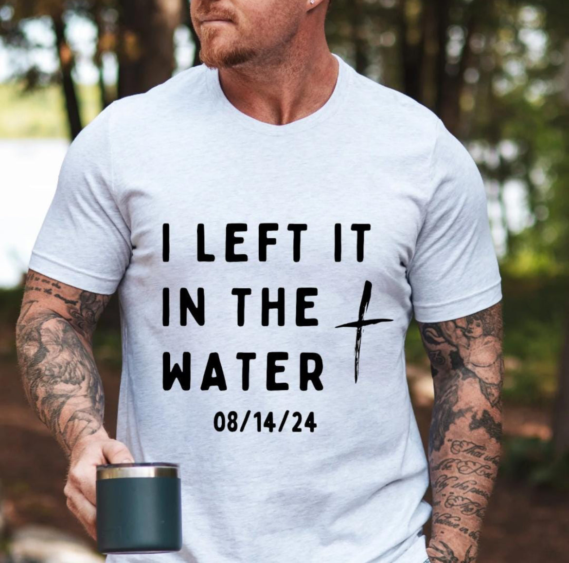 Ash white crewneck t-shirt that says, “I left it in the water” with a custom baptism date underneath.