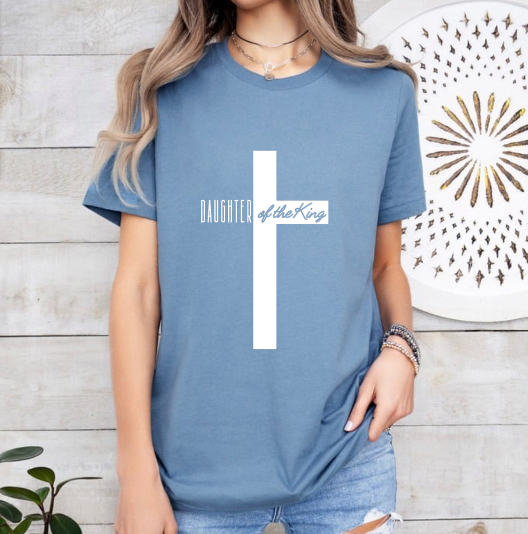 Steel blue crewneck t-shirt that says, “Daughter of the King” running through a cross.