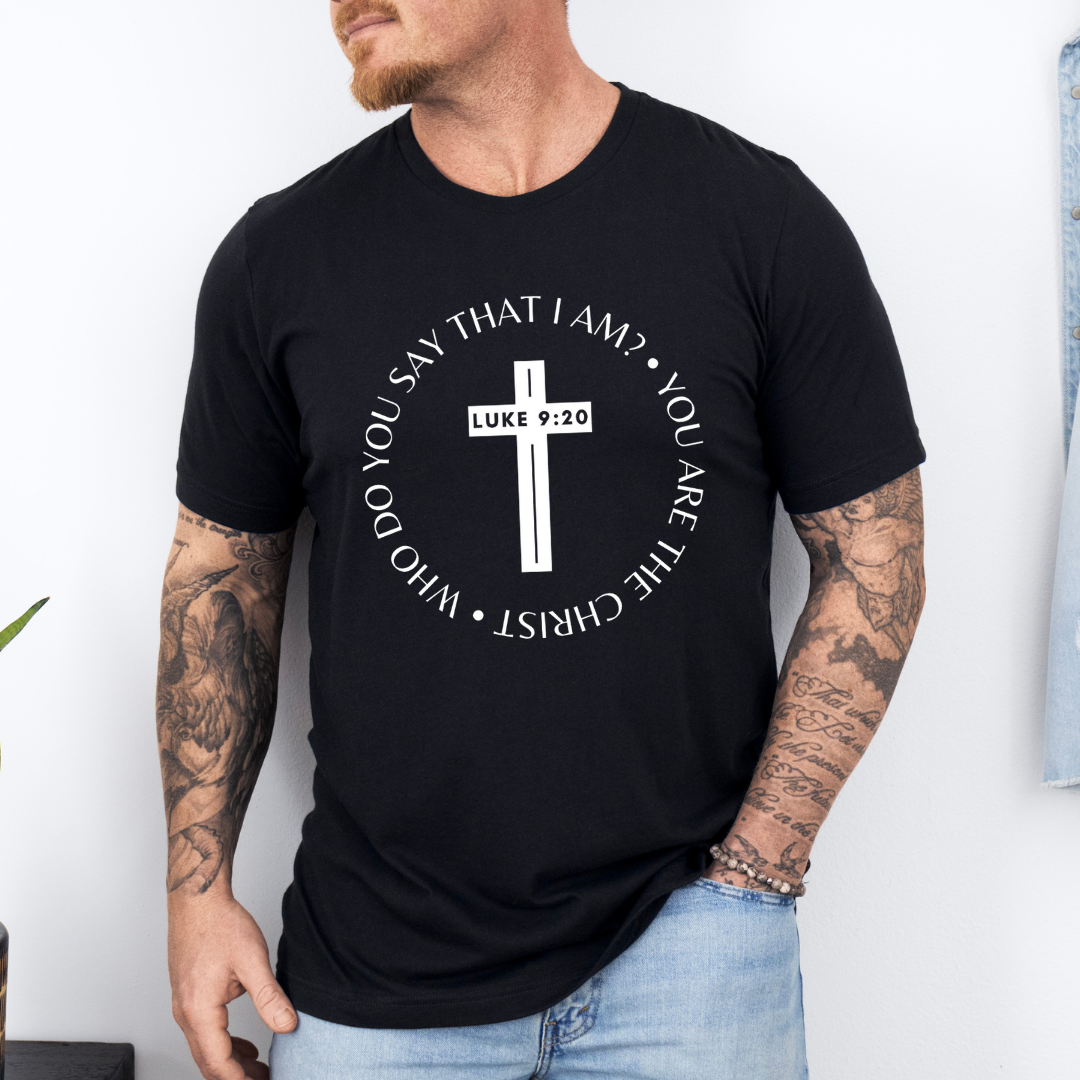 Black crewneck t-shirt that says, “who do you say that I am? you are the Christ?” With a cross that says, “Luke 9:29” through the middle.