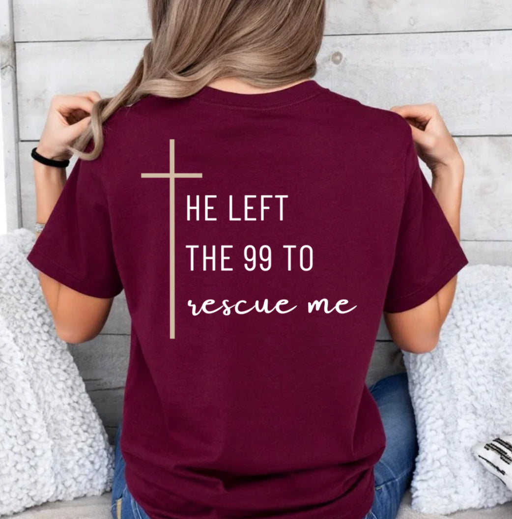 Maroon crewneck T-Shirt that says, "He left the 99 to rescue me" with a large tan cross. On the front it says, "Matthew 18:13 rescued" with a tan sheep.