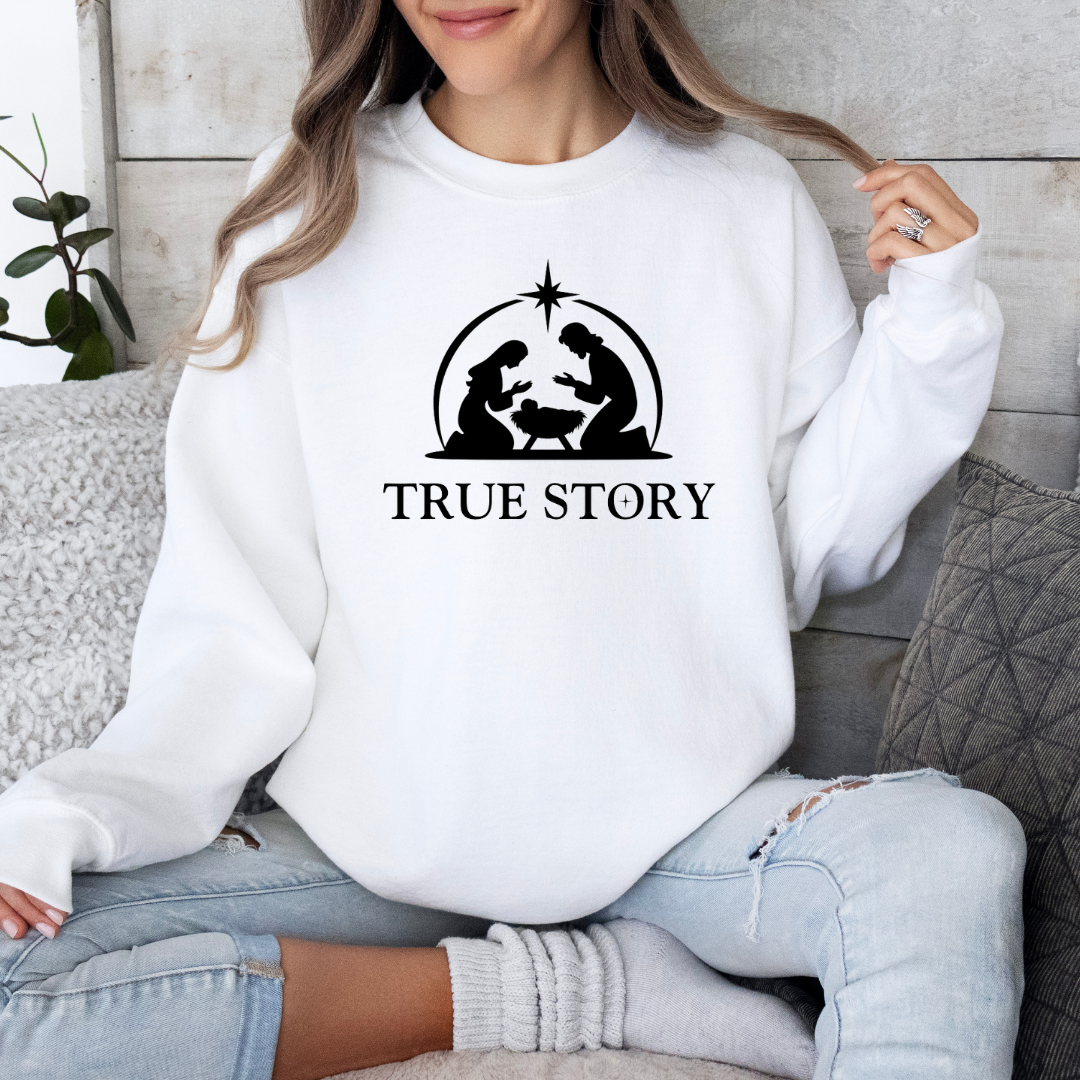 White crewneck Christmas sweatshirt that says, "true story" featuring Jesus, Mary and Jesus in a manger.