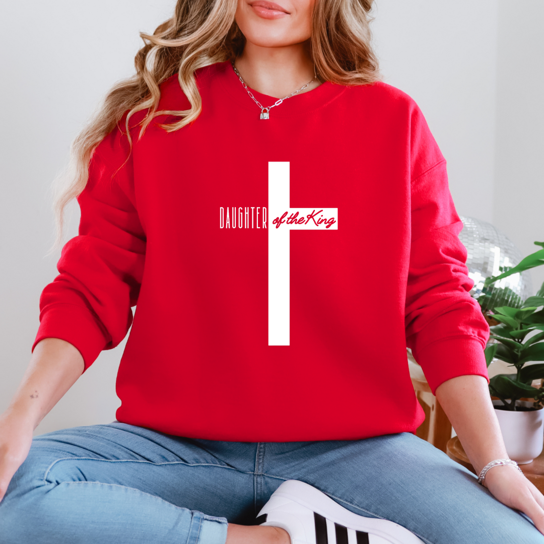 Red sweatshirt that says, "daughter of the King" across the middle of a large cross.