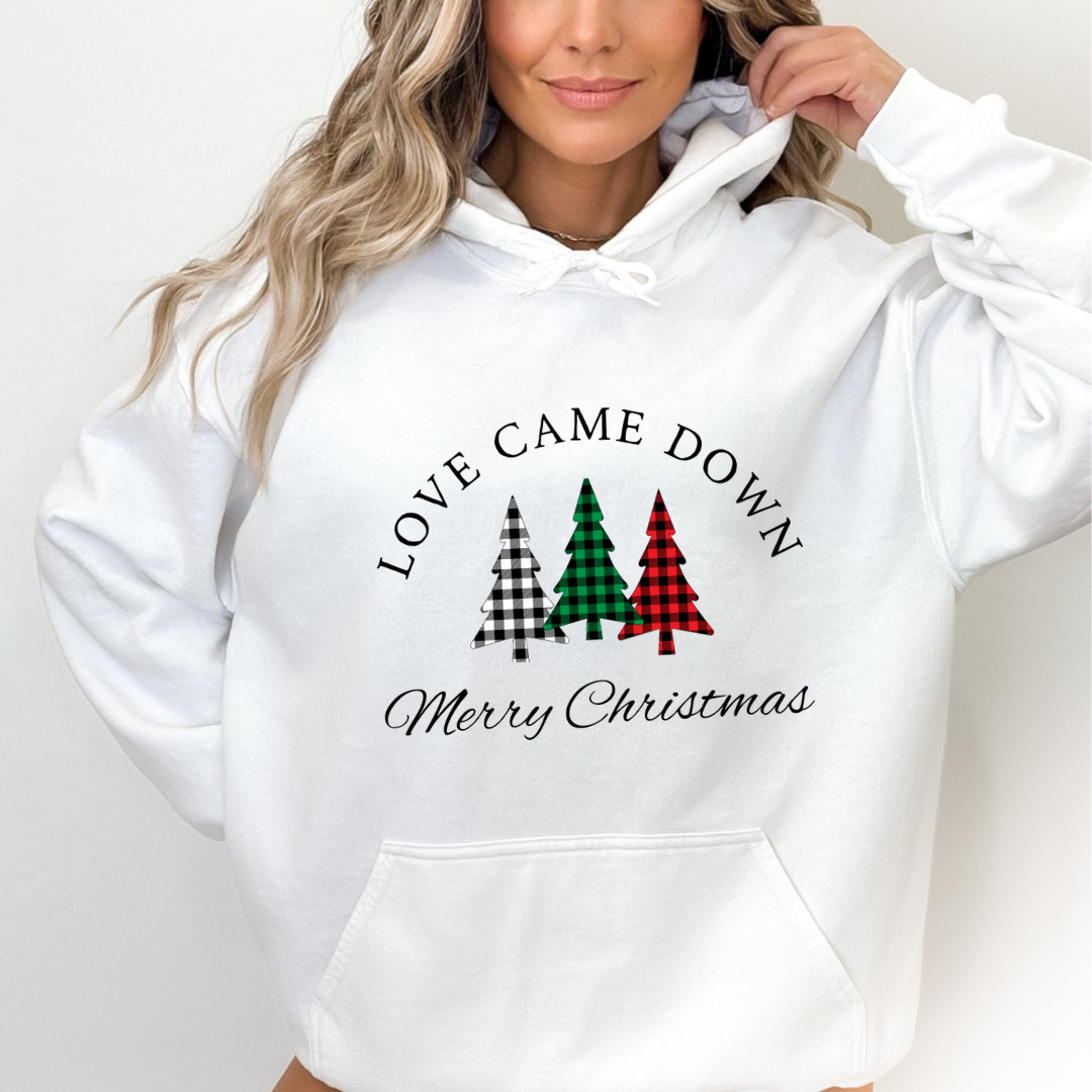 White hoodie sweatshirt that says, "Love came down. Merry Christmas" with three Christmas trees in buffalo plaid green, red and black.