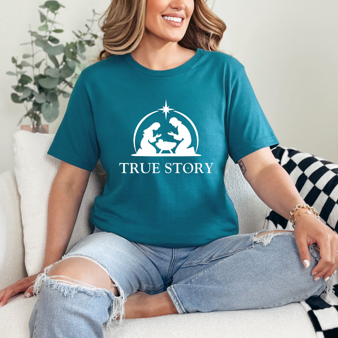 Deep teal crewneck t-shirt that says, “true story” with Mary, Joseph and baby Jesus in a manger. Christian Christmas Holiday attire.