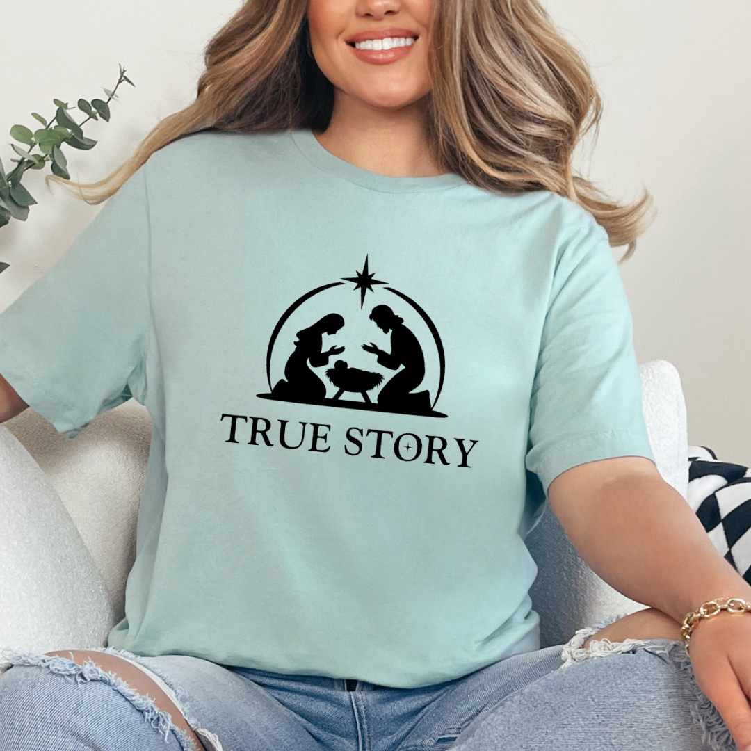 Dusty green crewneck t-shirt that says, “true story” with Mary, Joseph and baby Jesus in a manger. Christian Christmas Holiday attire.