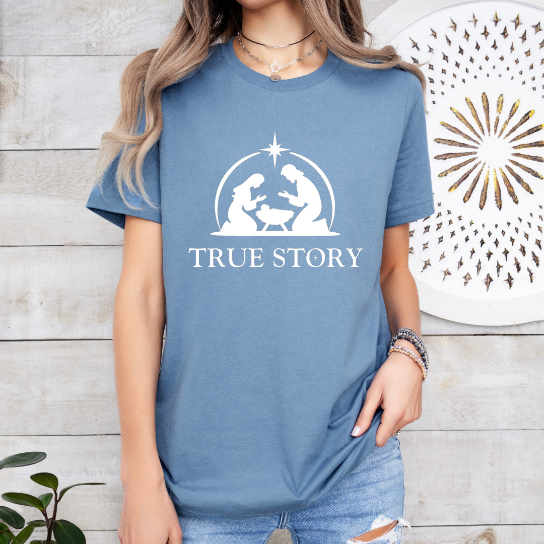 Steel blue crewneck t-shirt that says, “true story” with Mary, Joseph and baby Jesus in a manger. Christian Christmas Holiday attire.