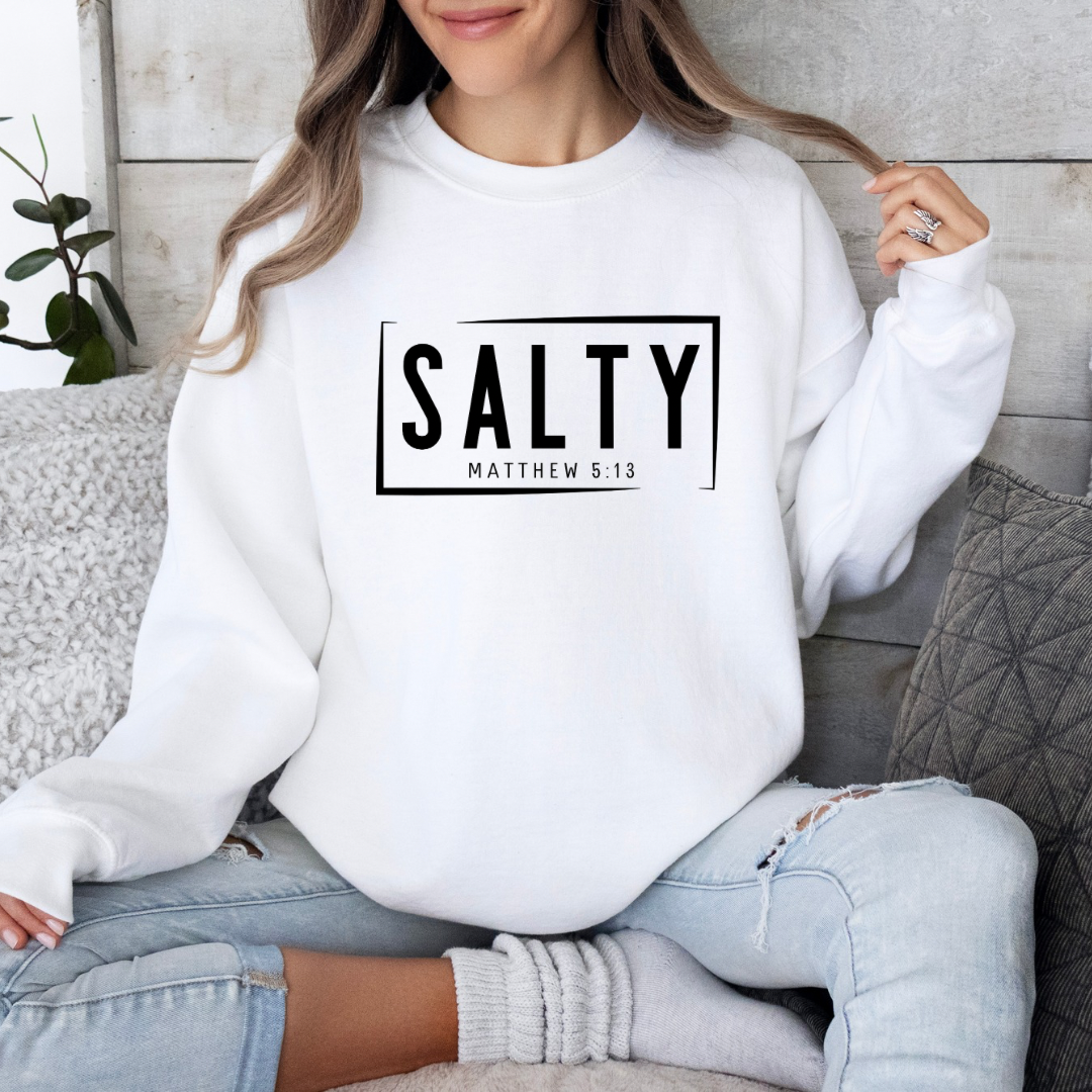 White Crewneck sweatshirt that says, “SALTY” in large capital letters. Underneath in smaller letters it says, “Matthew 5:13.”