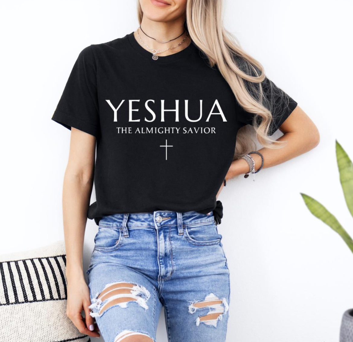 Black Crewneck T-shirt that says, “Yeshua” in large letters. Underneath in smaller letters it says, “the almighty savior” and under that is a small cross. 