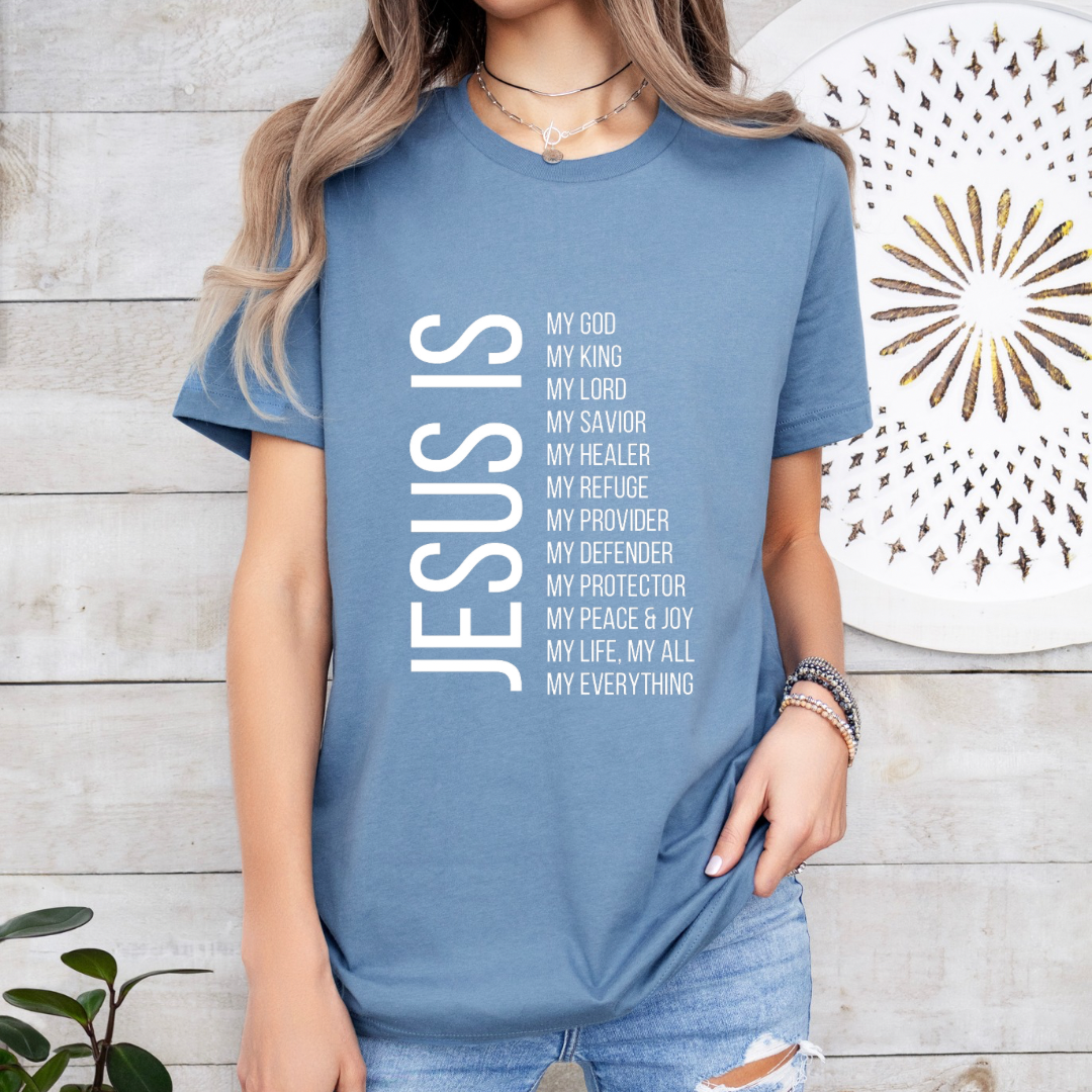 Steel blue crewneck t-shirt that says, “Jesus Is my, God, king, Lord, savior, healer, refuge, provider, defender, protection, peace. joy, life, all, everything.”