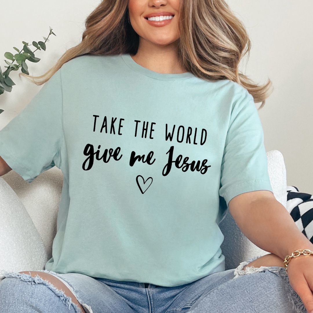 Dusty Green crewneck t-shirt that says, “take the world, give me Jesus” with a heart graphic.