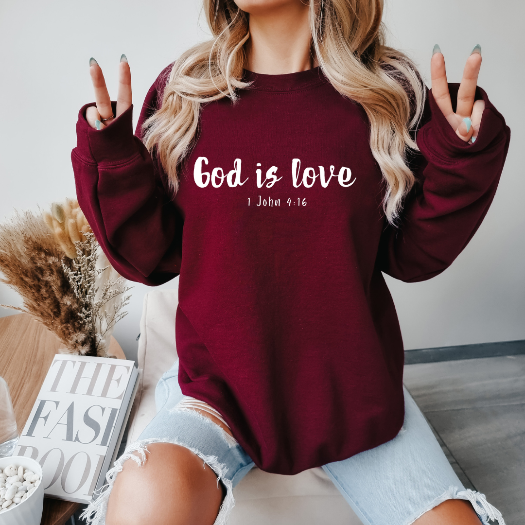 Maroon crewneck sweatshirt that says, “God is love. 1 John 4:16.” 