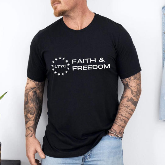 Black crewneck t-shirt that says, “Faith and freedom” with a Betsy Ross flag star symbol and in the middle it says, “1776”.