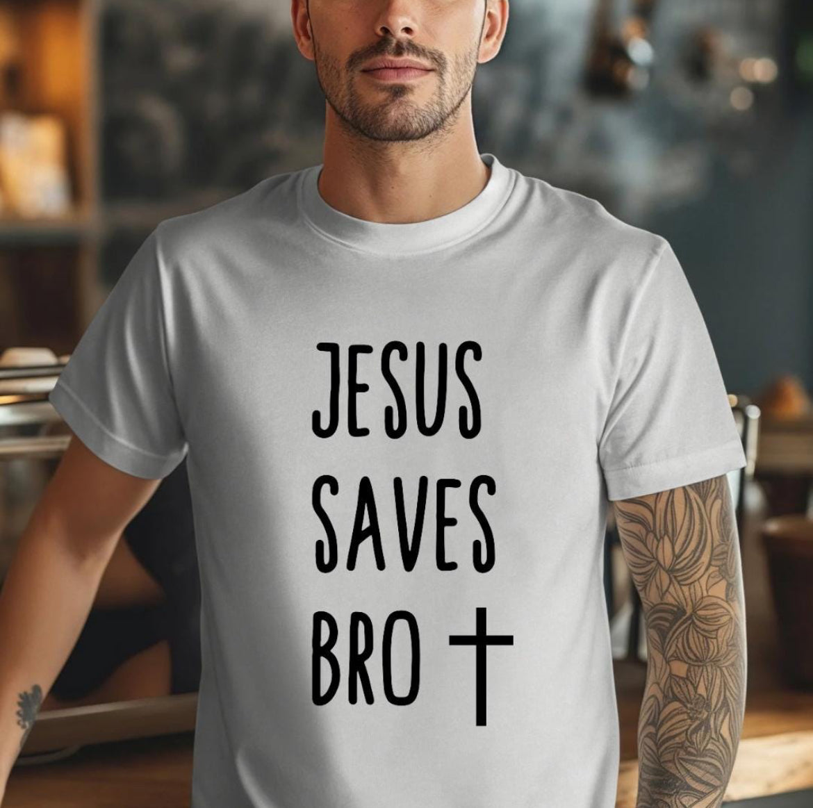 Grey crewneck t-shirt that says, “Jesus saves bro” with a cross. 