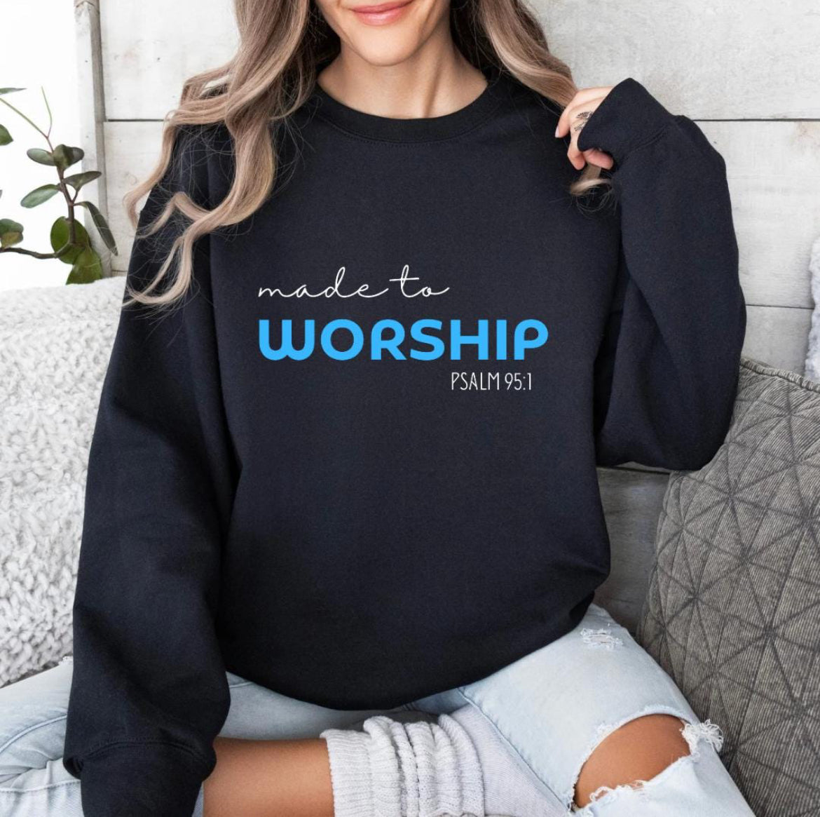 Black crewneck sweatshirt that says, "Made to worship" where the word "worship" Is a bright blue. Underneath in smaller letters it says, "Psalm 95 1."