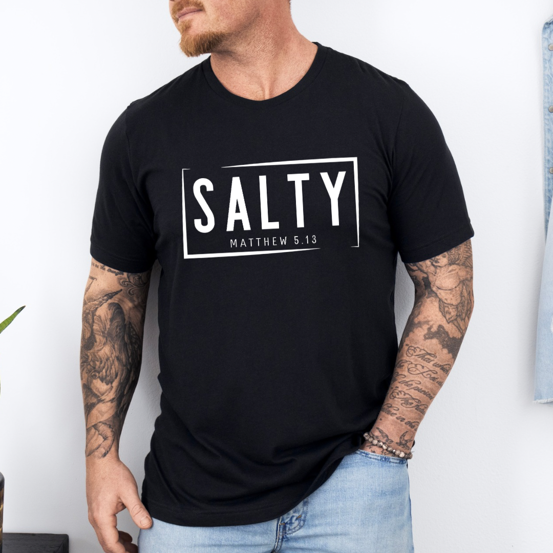 Black crewneck t-shirt that says, “SALTY” in large capital letters. Underneath in smaller letters it says, “Matthew 5:13.” Christian Apparel