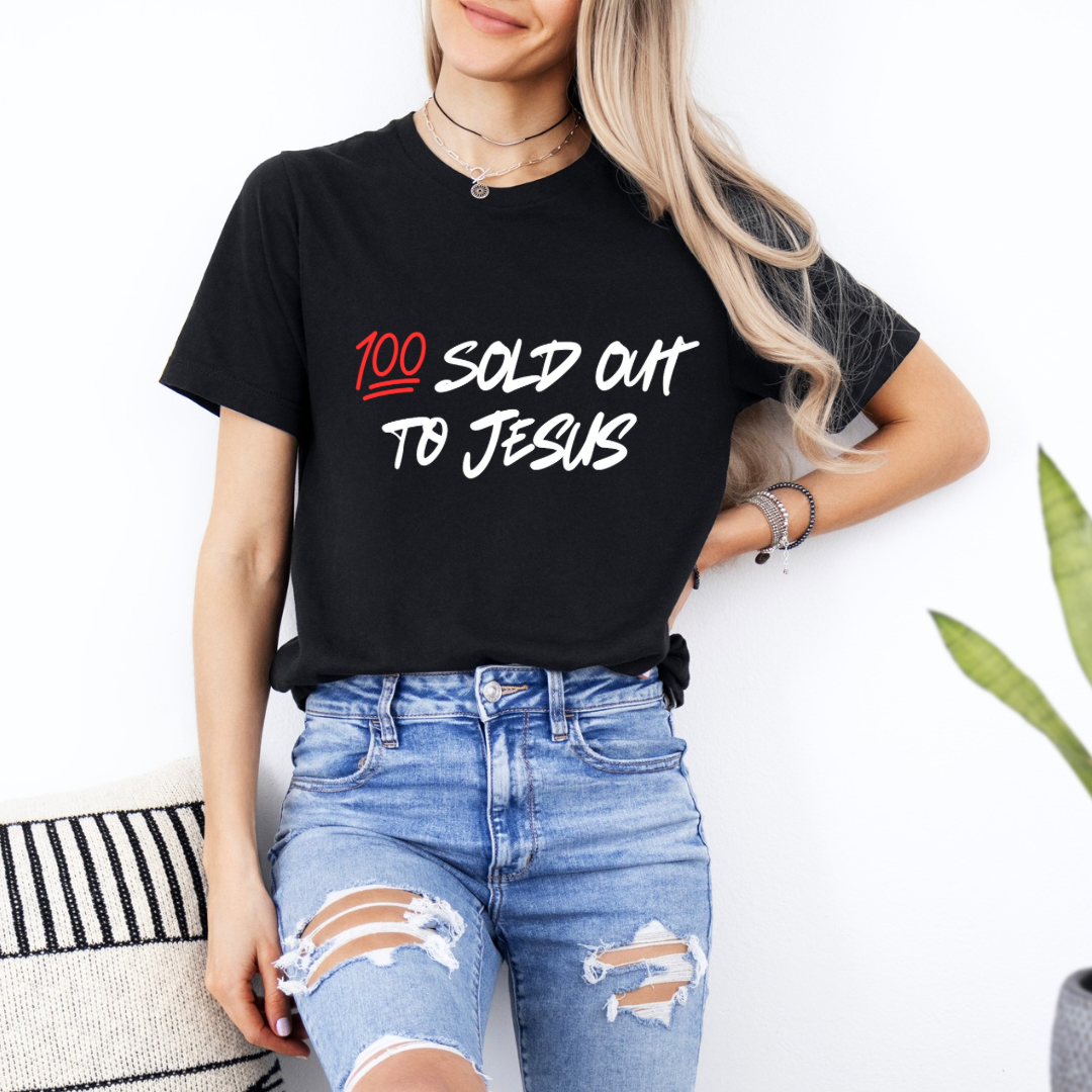 Black crewneck t-shirt that says, “sold out to Jesus” with a “100 emoji”.