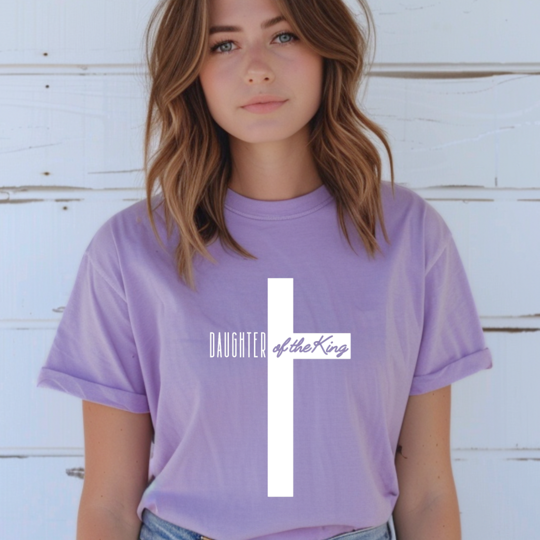 Lavender crewneck t-shirt that says, “Daughter of the King” running through a cross. 