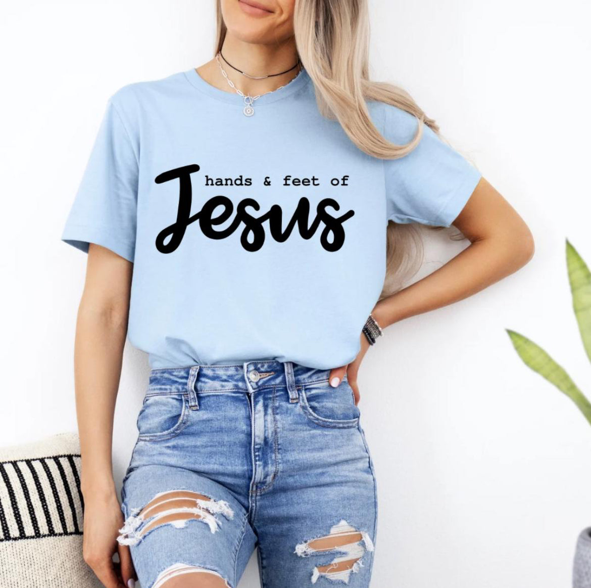 Baby blue crewneck t-shirt that says, “hands and feet of Jesus.”