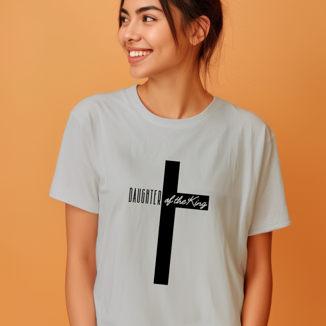 Grey crewneck t-shirt that says, “Daughter of the King” running through a cross. 