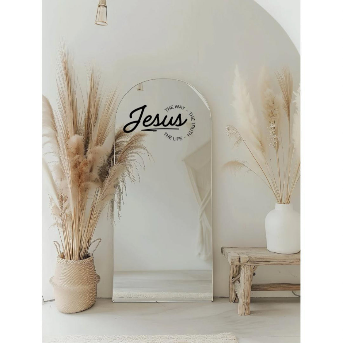 Mirror decal sticker that says, “Jesus - the way, the truth, the life.” The word “Jesus” is in large cursive letters. The other words are in print and round the ending of “Jesus”.