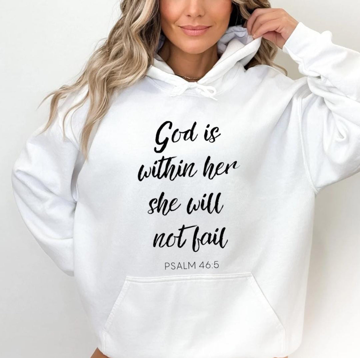 white hoodie that says, "God is within her she will not fail." Underneath in smaller letters it says, "Psalm 46 5." On the sleeve there is a bones peace sing.