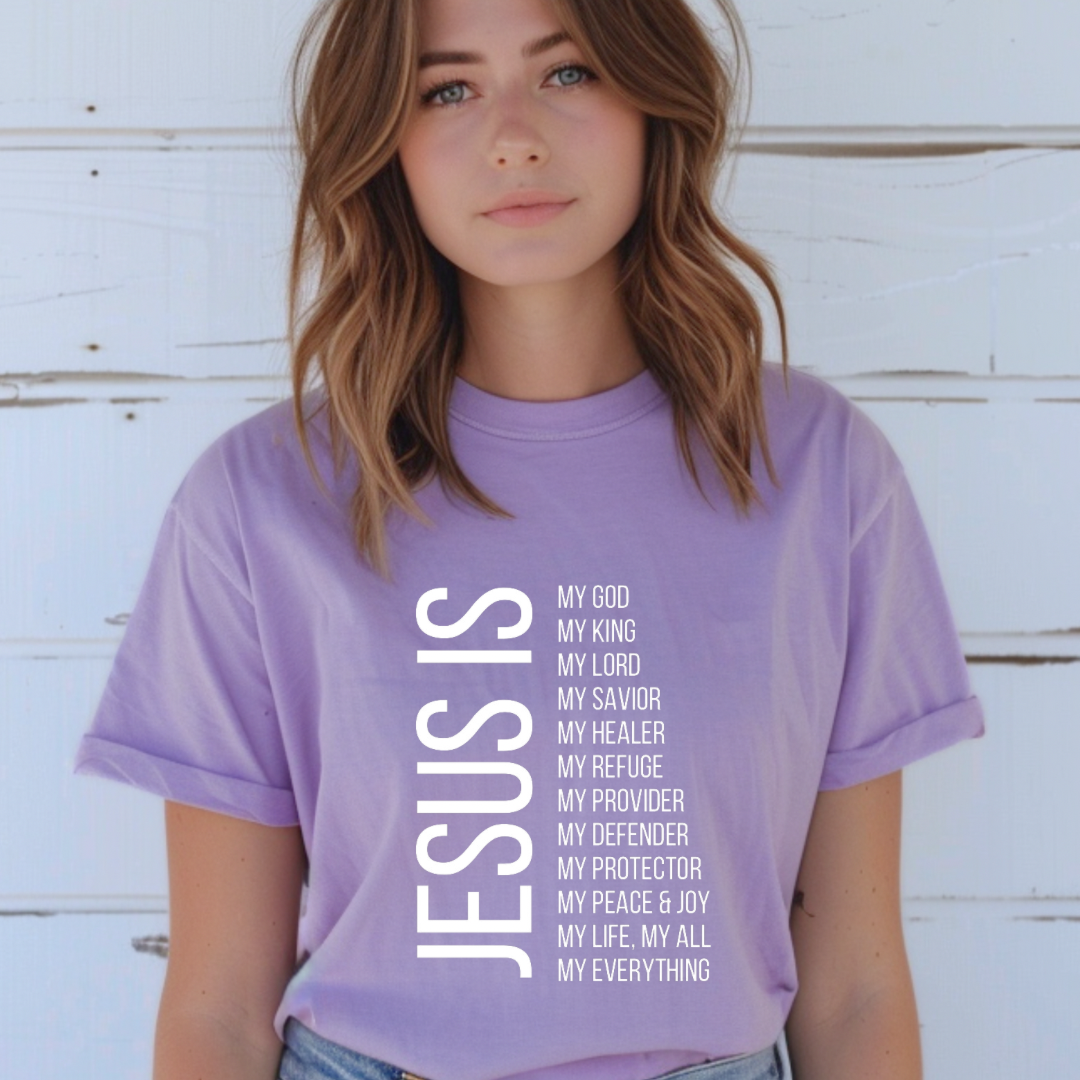 Lavender crewneck t-shirt that says, “Jesus Is my, God, king, Lord, savior, healer, refuge, provider, defender, protection, peace. joy, life, all, everything.”