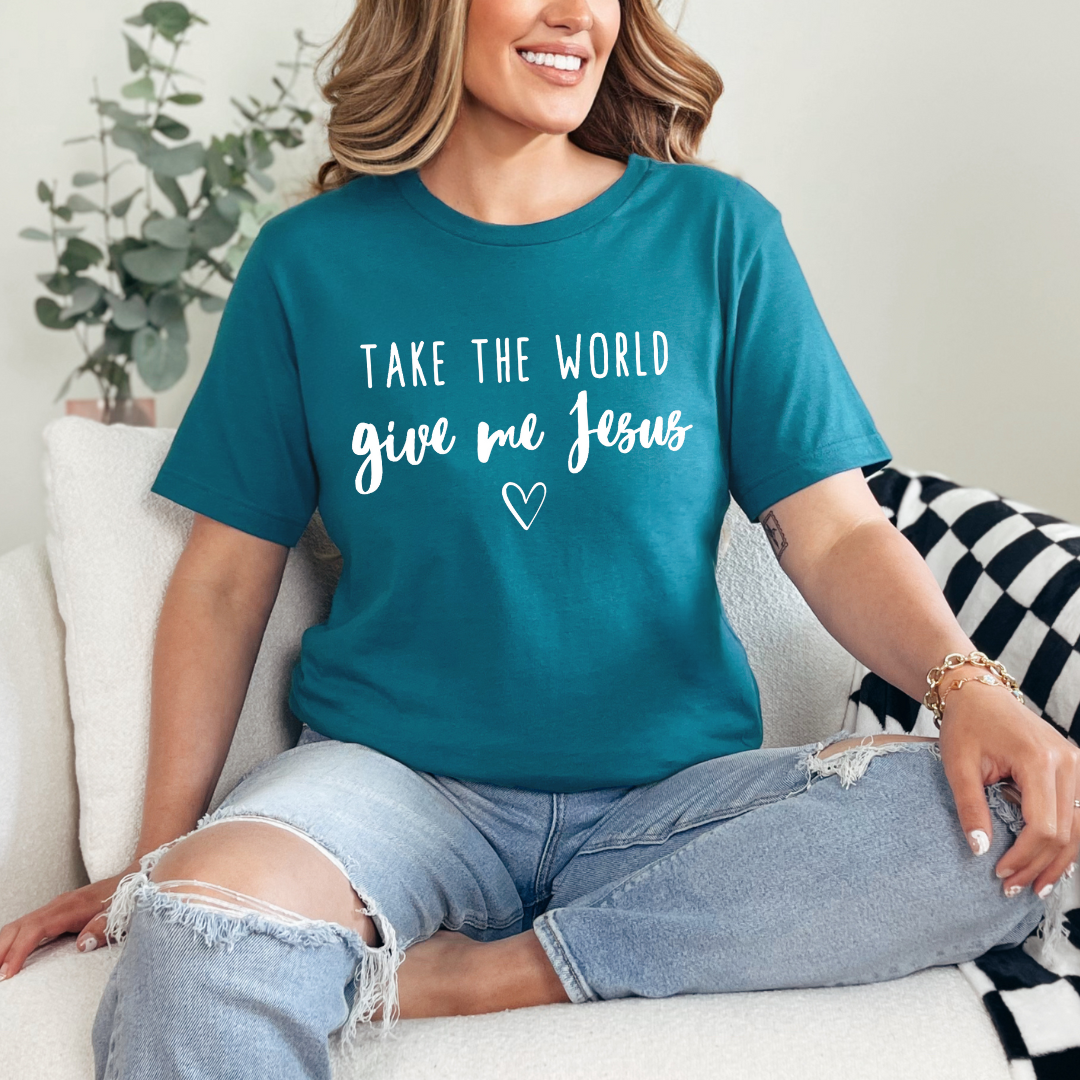 Deep teal crewneck t-shirt that says, “take the world, give me Jesus” with a heart graphic.