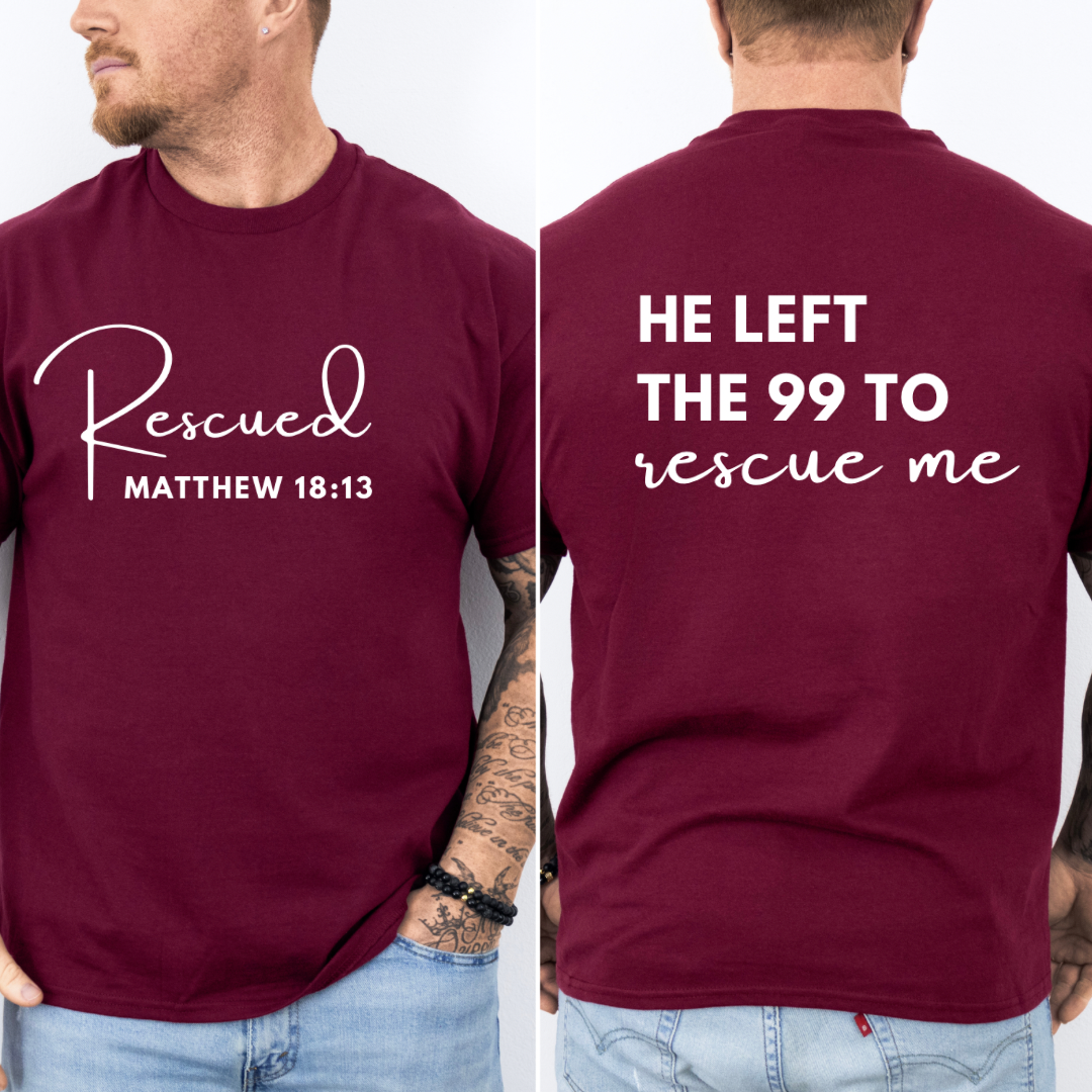 crewneck T-Shirt that says, "He left the 99 to rescue me". On the front it says, "Matthew 18:13 rescued" with a tan sheep.