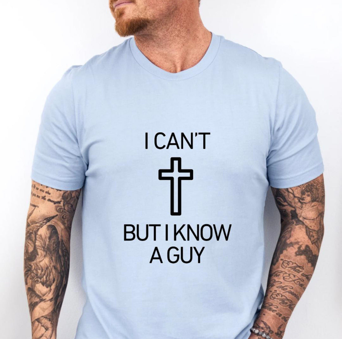 Baby blue crewneck t-shirt that says, “I can’t but I know a guy” with a cross in the middle.