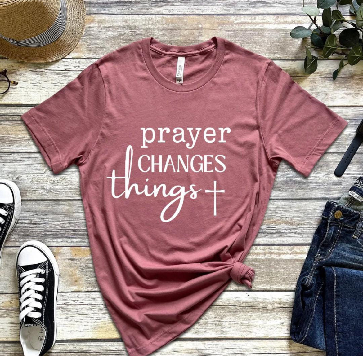 Mauve crewneck t-shirt that says, “prayer changes things.”