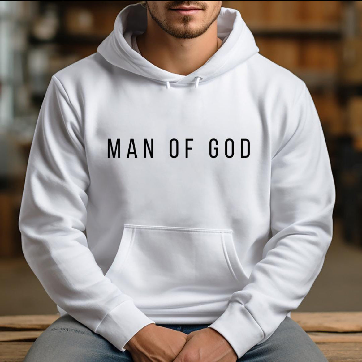 white hoodie that says, "Man of God" in bold letters across the chest.