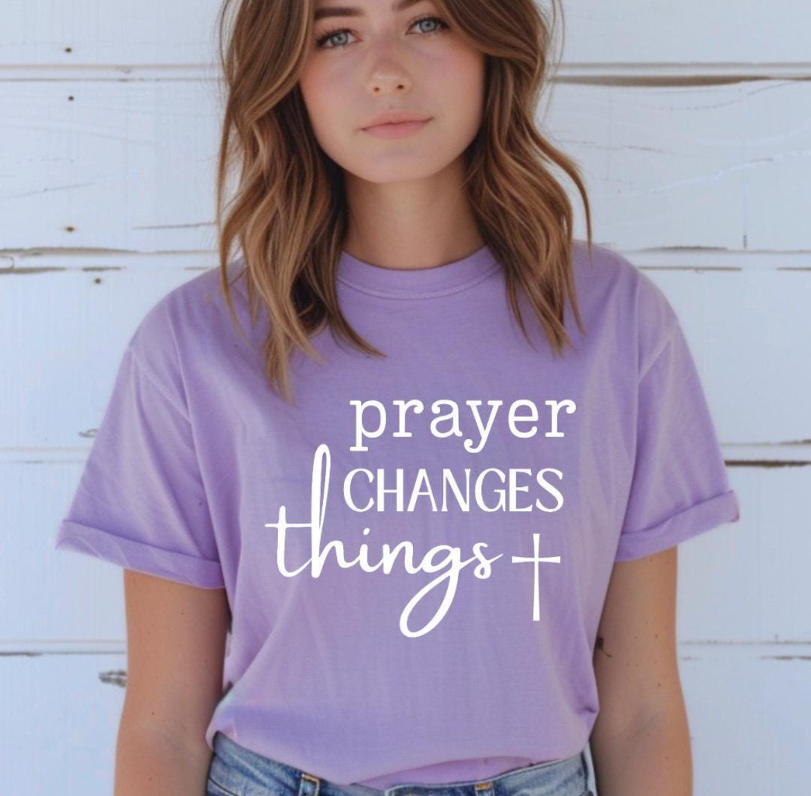 Lavender crewneck t-shirt that says, “prayer changes things.”