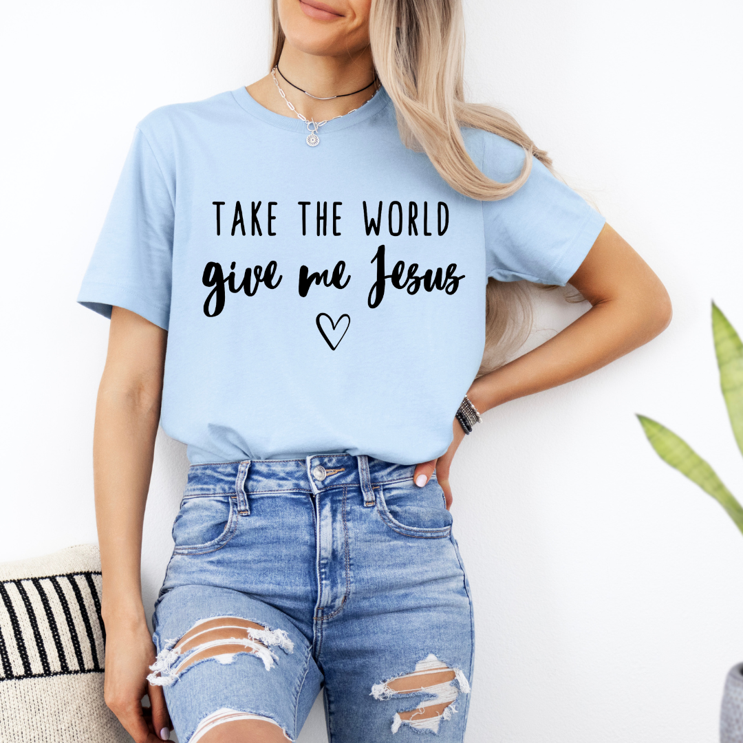 Baby blue crewneck t-shirt that says, “take the world, give me Jesus” with a heart graphic.