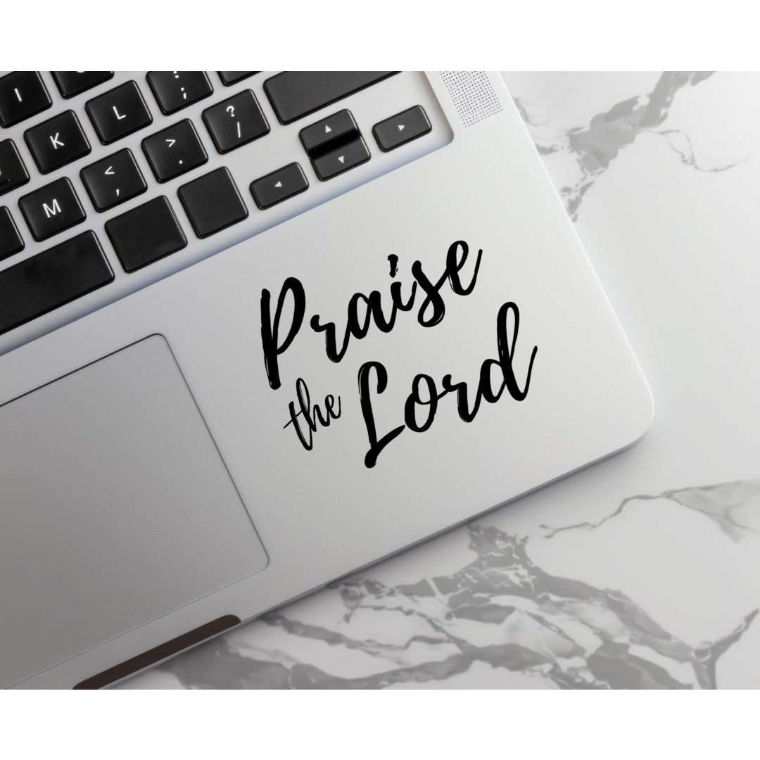 Laptop keyboard sticker that says, "Praise the Lord."