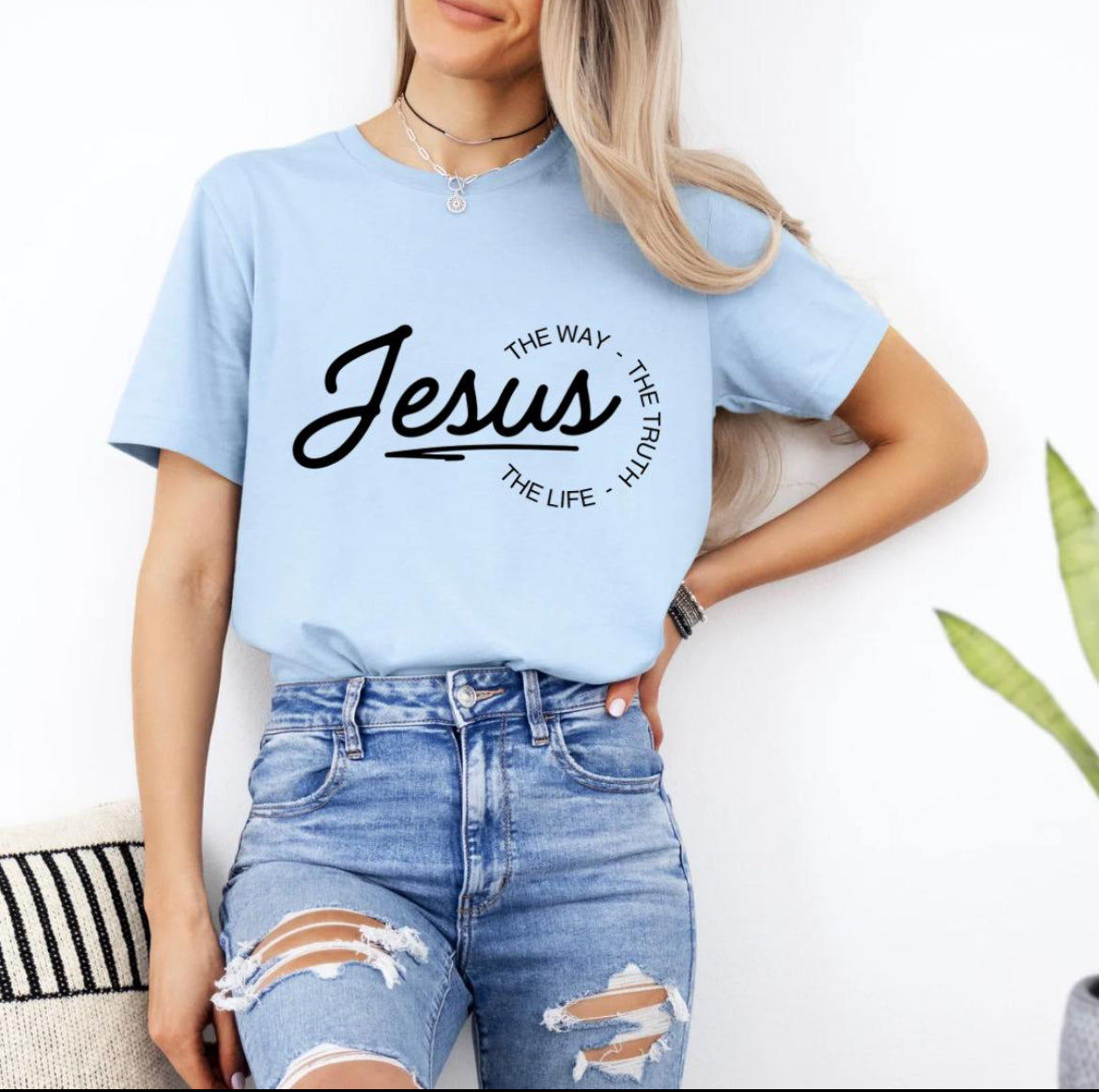 Baby blue crewneck t-shirt that says, “Jesus the way the truth the life.”