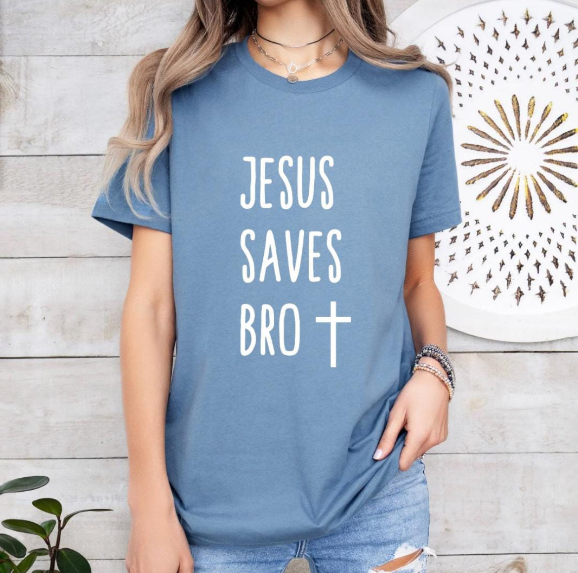 Steel blue crewneck t-shirt that says, “Jesus saves bro” with a cross. 