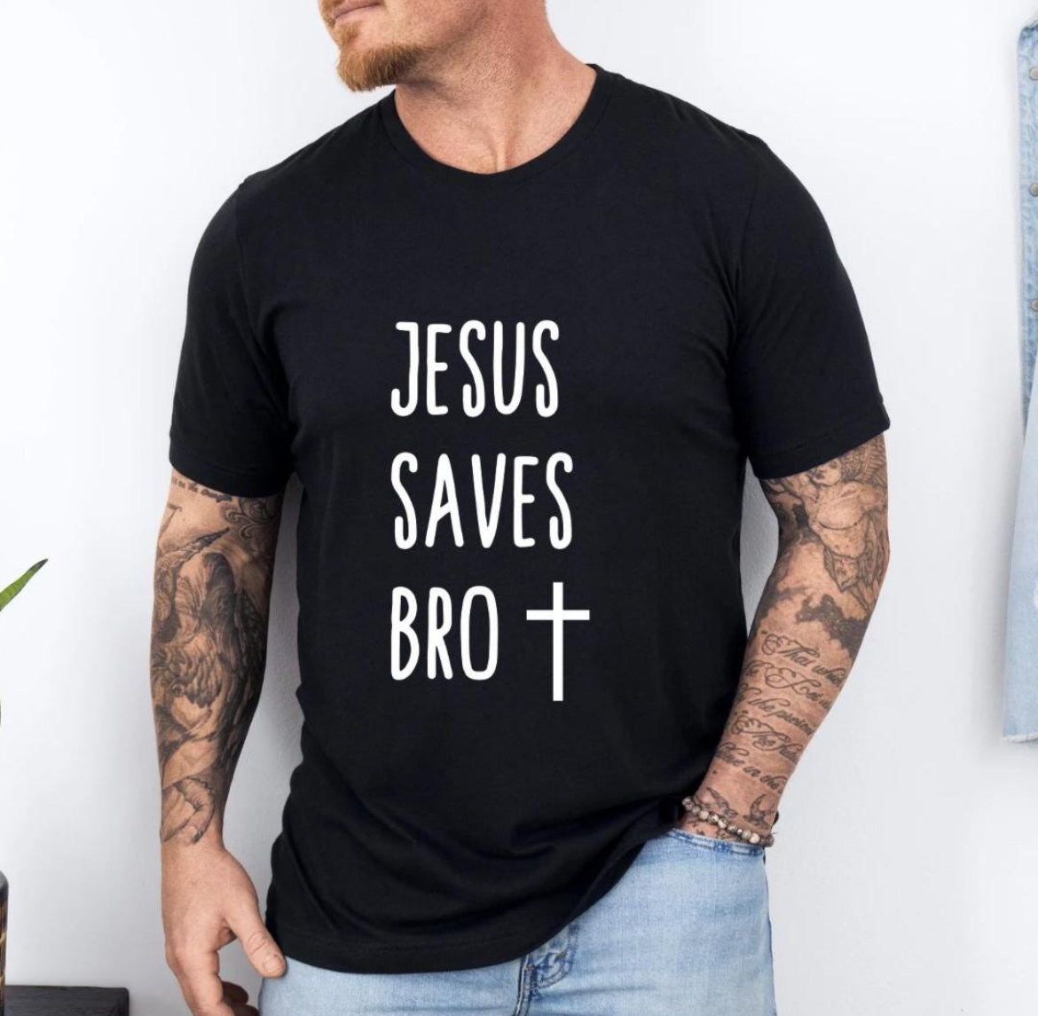 Black crewneck t-shirt that says, “Jesus saves bro” with a cross. 