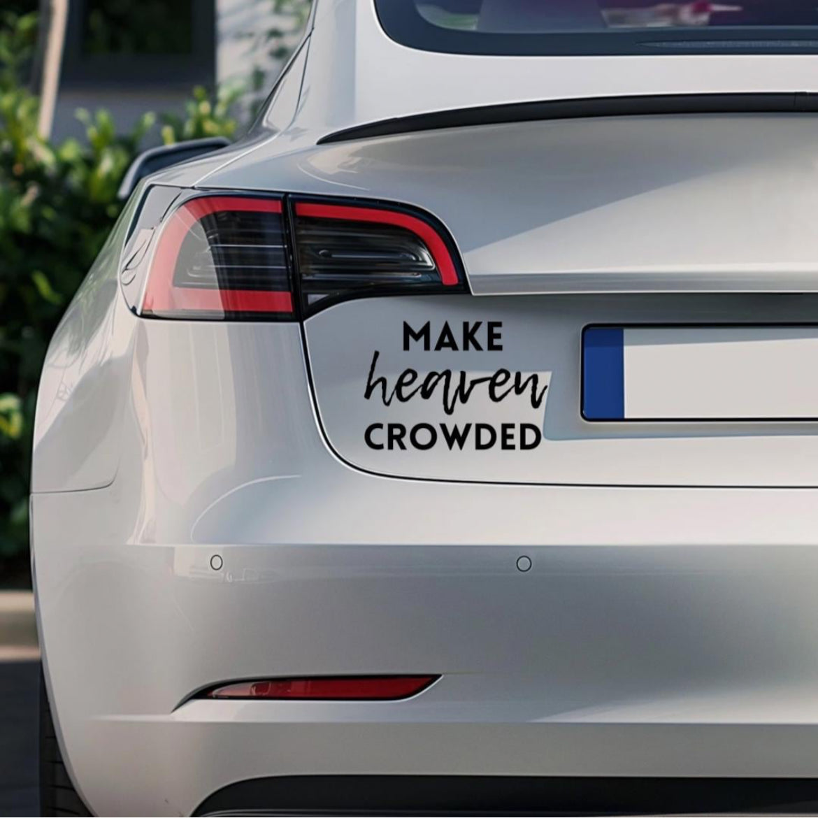 Bumper sticker car decal that says, “make heaven crowded.” The word “heaven” is in cursive. 