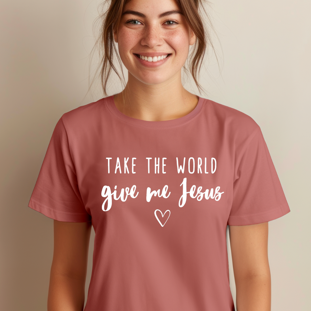 Mauve crewneck t-shirt that says, “take the world, give me Jesus” with a heart graphic.