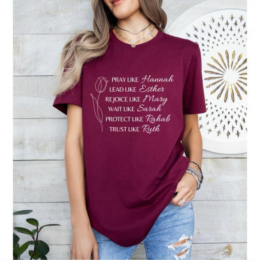 Maroon crewneck t-shirt that says, “Pray like Hannah, lead like Esther, rejoice like Mary, wait like Sarah, protect like Rahab, trust like Ruth.”