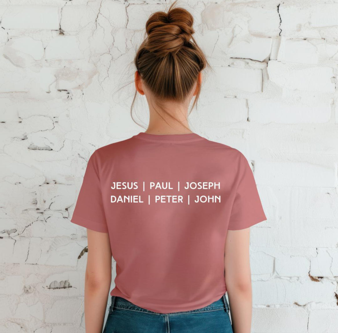 Back of a maybe crewneck t-shirt that says, “Jesus, Paul, Joseph, Daniel, Peter, John.”